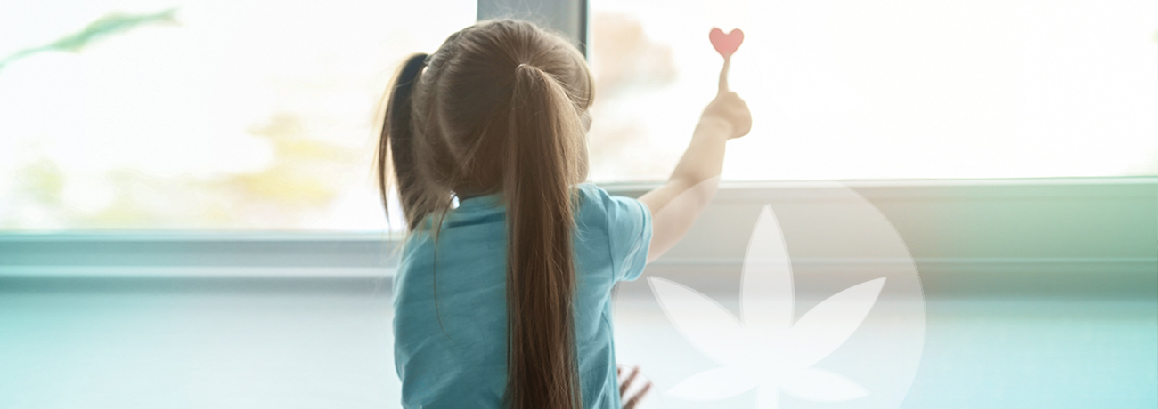 little girl in front of window